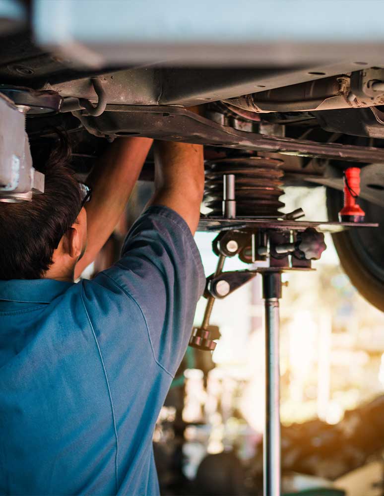 Mechanic working under car